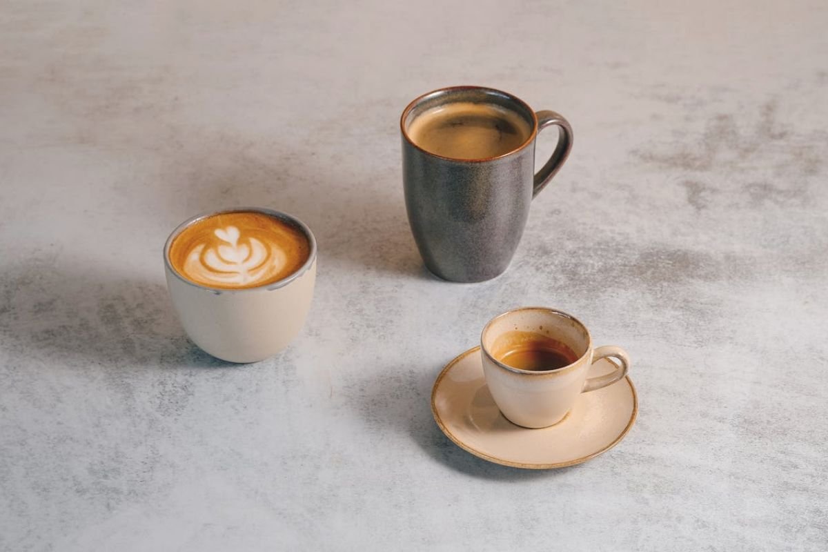Assorted coffee and tea cups on a modern wooden table