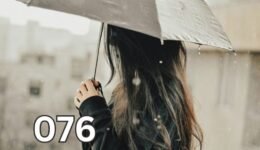 Woman standing in the rain holding an umbrella, symbolising self-reliance and learning to protect yourself through difficult moments.