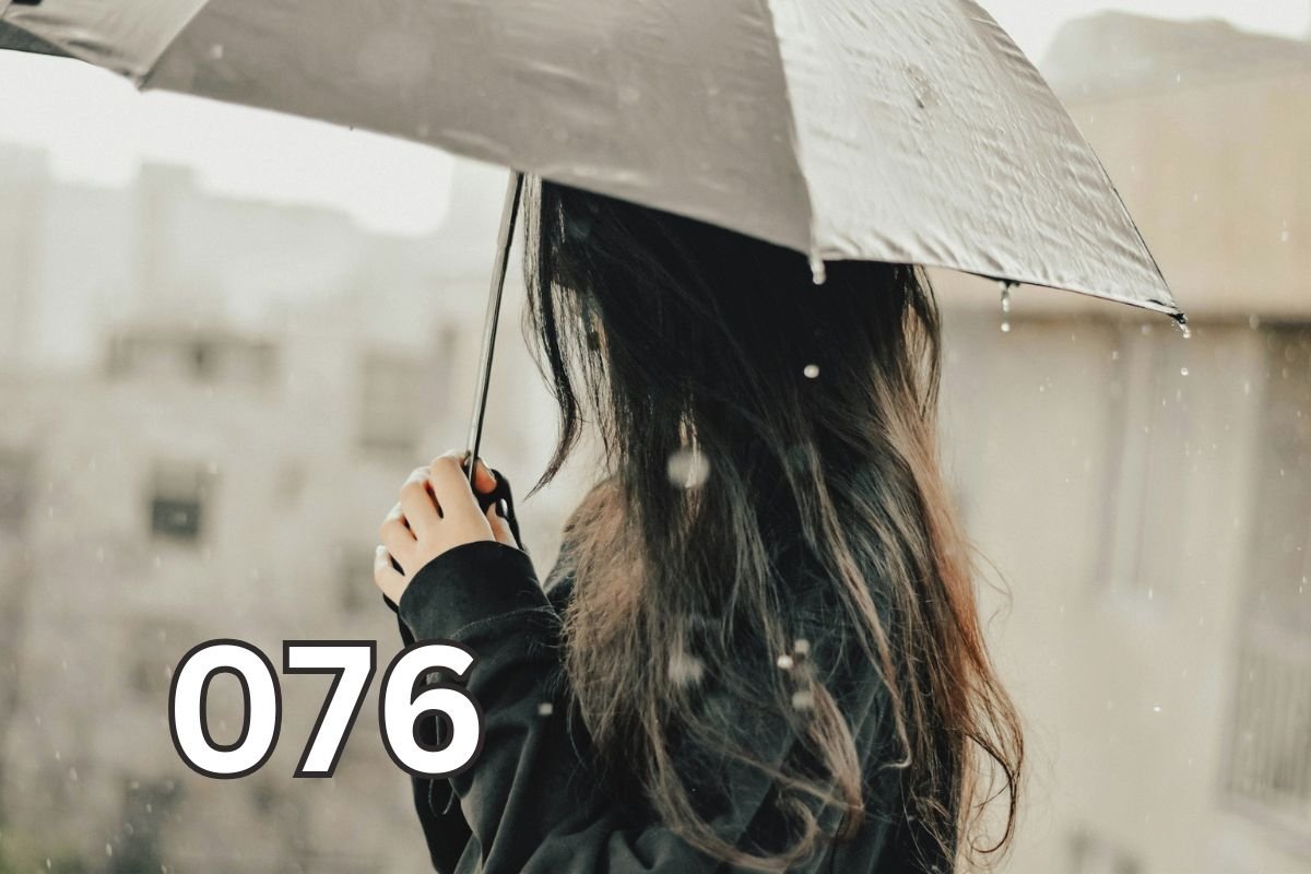 Woman standing in the rain holding an umbrella, symbolising self-reliance and learning to protect yourself through difficult moments.