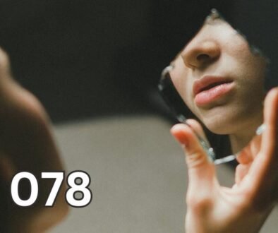 A person holding a broken mirror fragment showing only part of their face, symbolising how silent abuse quietly fractures a relationship.