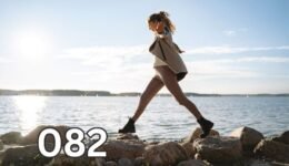 Woman balancing across coastal rocks alone, symbolising personal growth through lived experience and life lessons learned without advice.