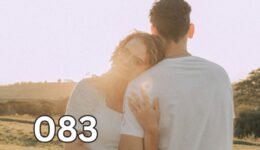 Woman leaning on her partner in an open field, illustrating emotional attachment despite distance.