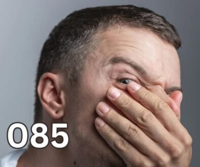 Man covering his nose and mouth with his hand looking uncomfortable, illustrating embarrassment from bad breath