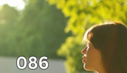 Woman standing in a sunny park with warm sunlight on her face, illustrating natural vitamin D production through sun exposure.