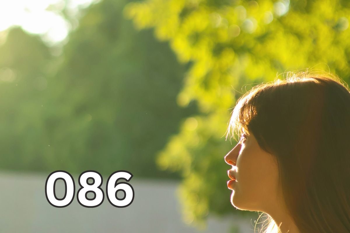 Woman standing in a sunny park with warm sunlight on her face, illustrating natural vitamin D production through sun exposure.