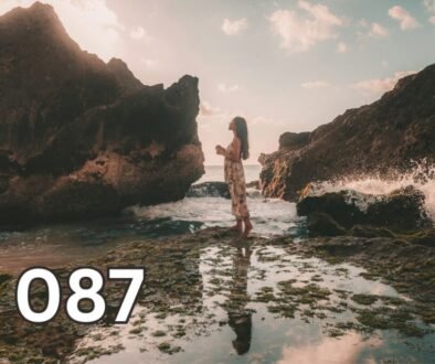 Person standing alone on rocks facing the horizon, symbolising living with integrity, self-respect, and staying true to personal values