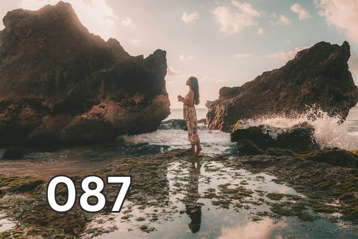 Person standing alone on rocks facing the horizon, symbolising living with integrity, self-respect, and staying true to personal values