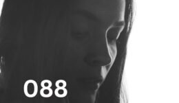 Sad woman looking down, reflecting relationship anxiety and emotional overwhelm in love