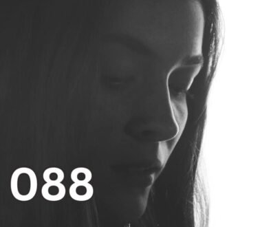 Sad woman looking down, reflecting relationship anxiety and emotional overwhelm in love