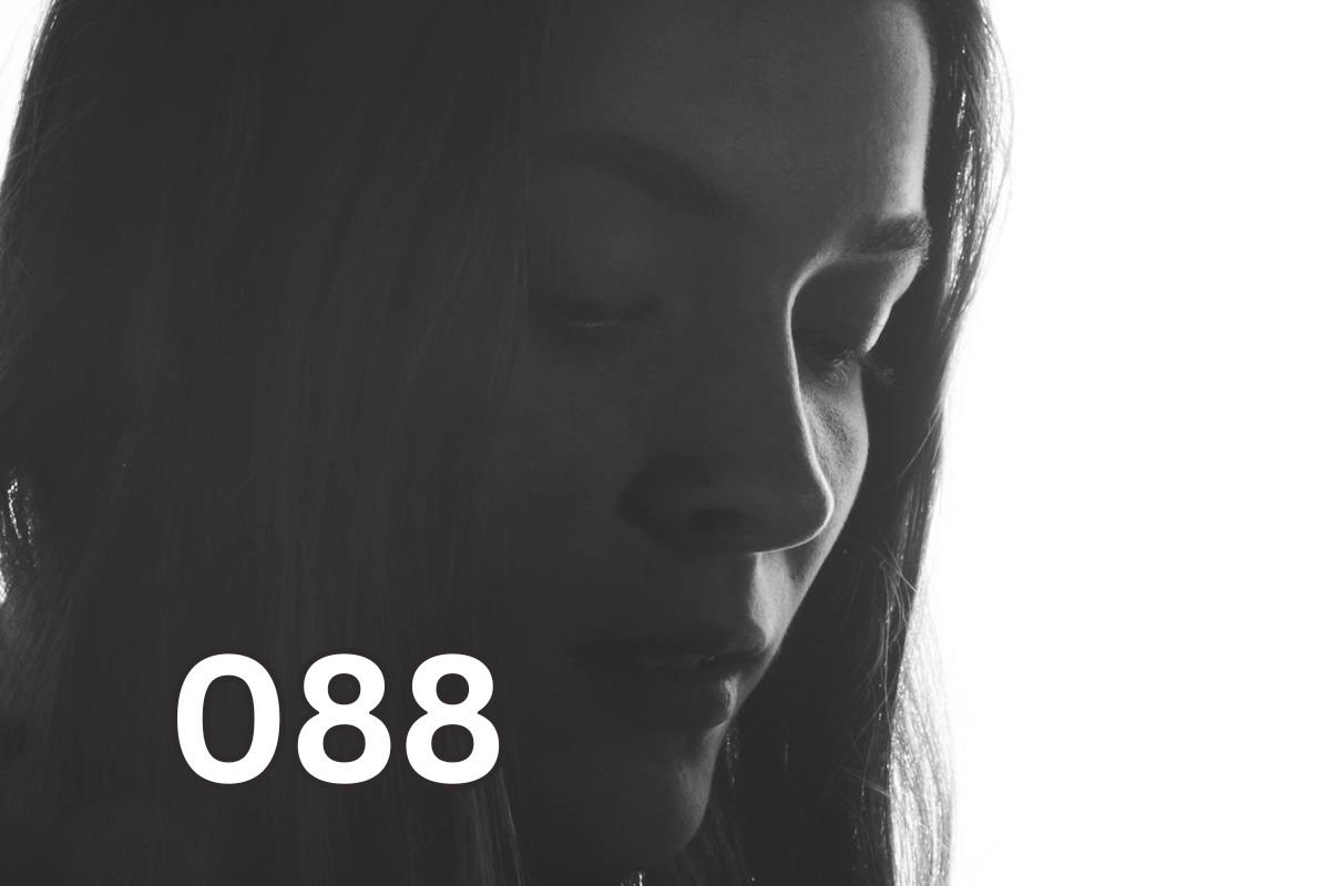 Sad woman looking down, reflecting relationship anxiety and emotional overwhelm in love
