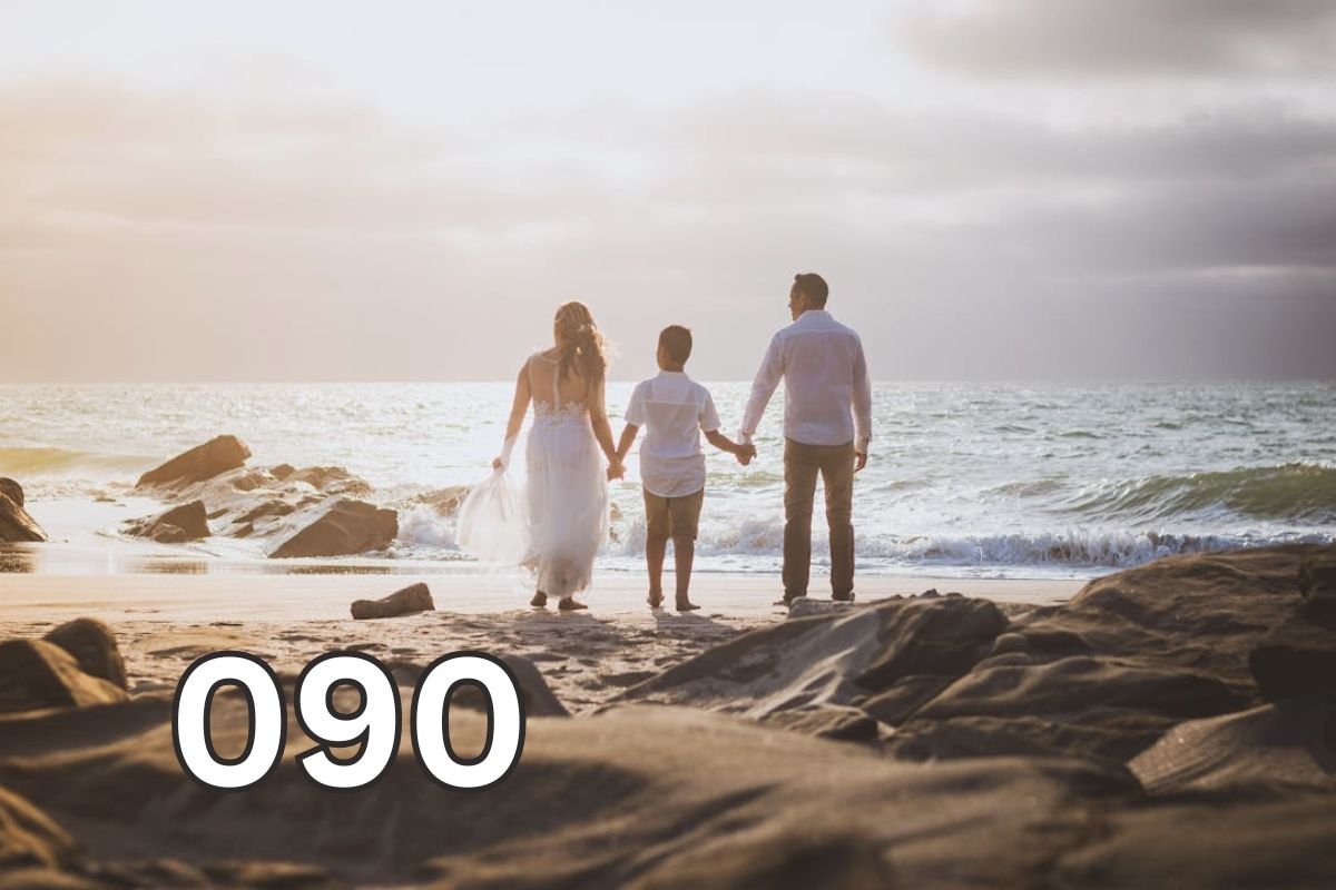 Parents holding their child’s hands while walking together on a beach, symbolising emotional support, healthy parenting, and family connection.