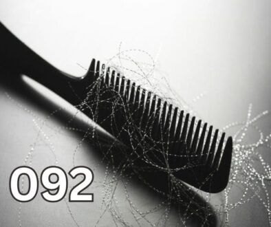 Black comb with strands of shed hair illustrating hair loss causes, thinning hair, and overall scalp and health concerns.