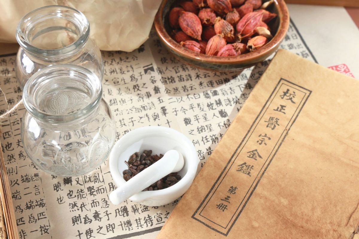 Traditional Chinese medicine tools and herbs representing holistic health, scalp health, healthy hair growth, and natural wellness practices.