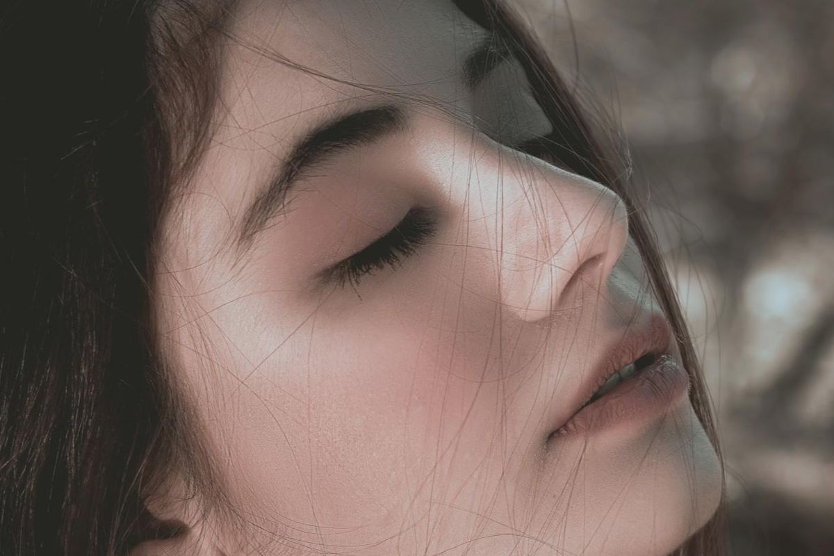 Woman with eyes closed reflecting on aphantasia, mental imagery, and discovering how differently human minds process imagination.