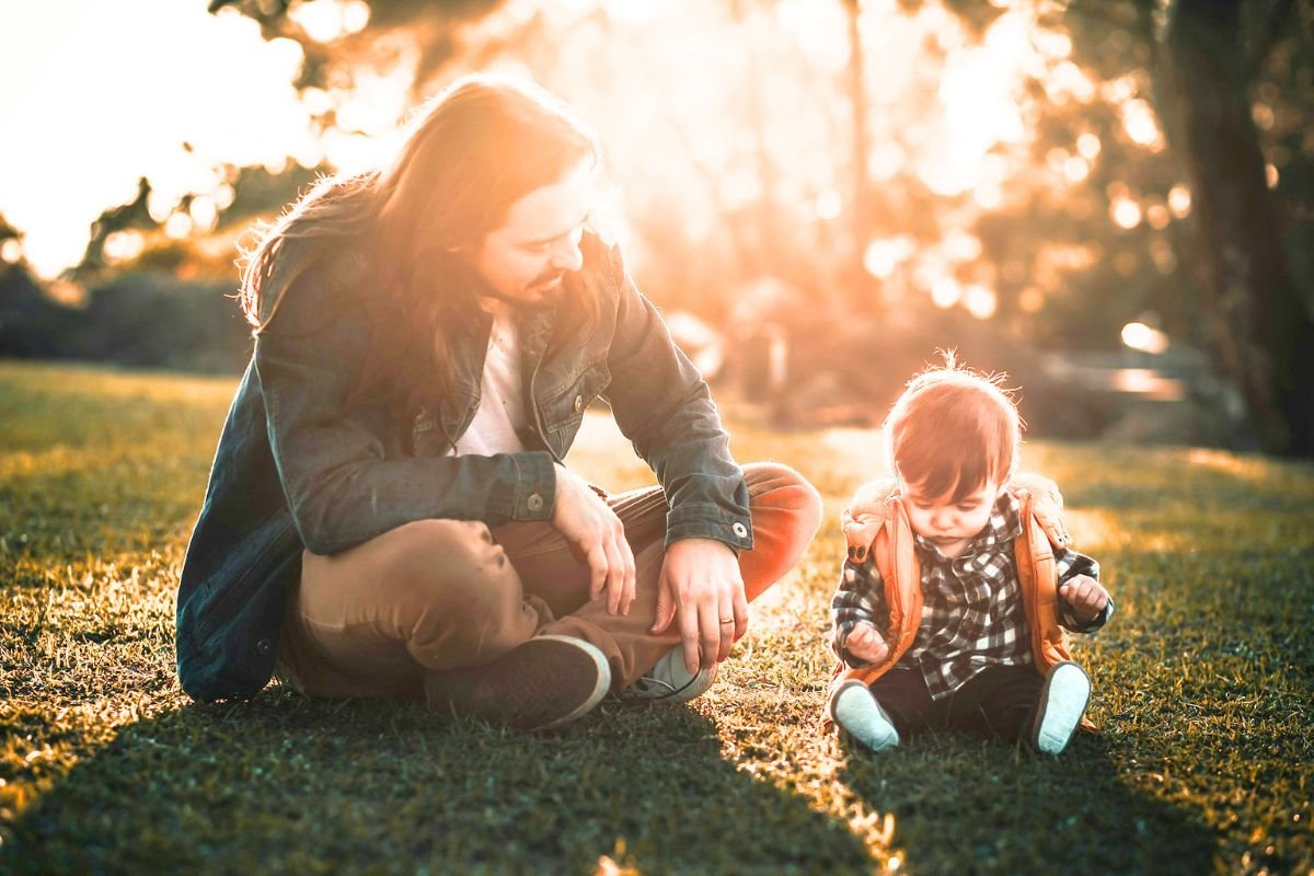 Adult comforting their younger self, representing inner child healing, self-compassion, and emotional healing from childhood trauma.