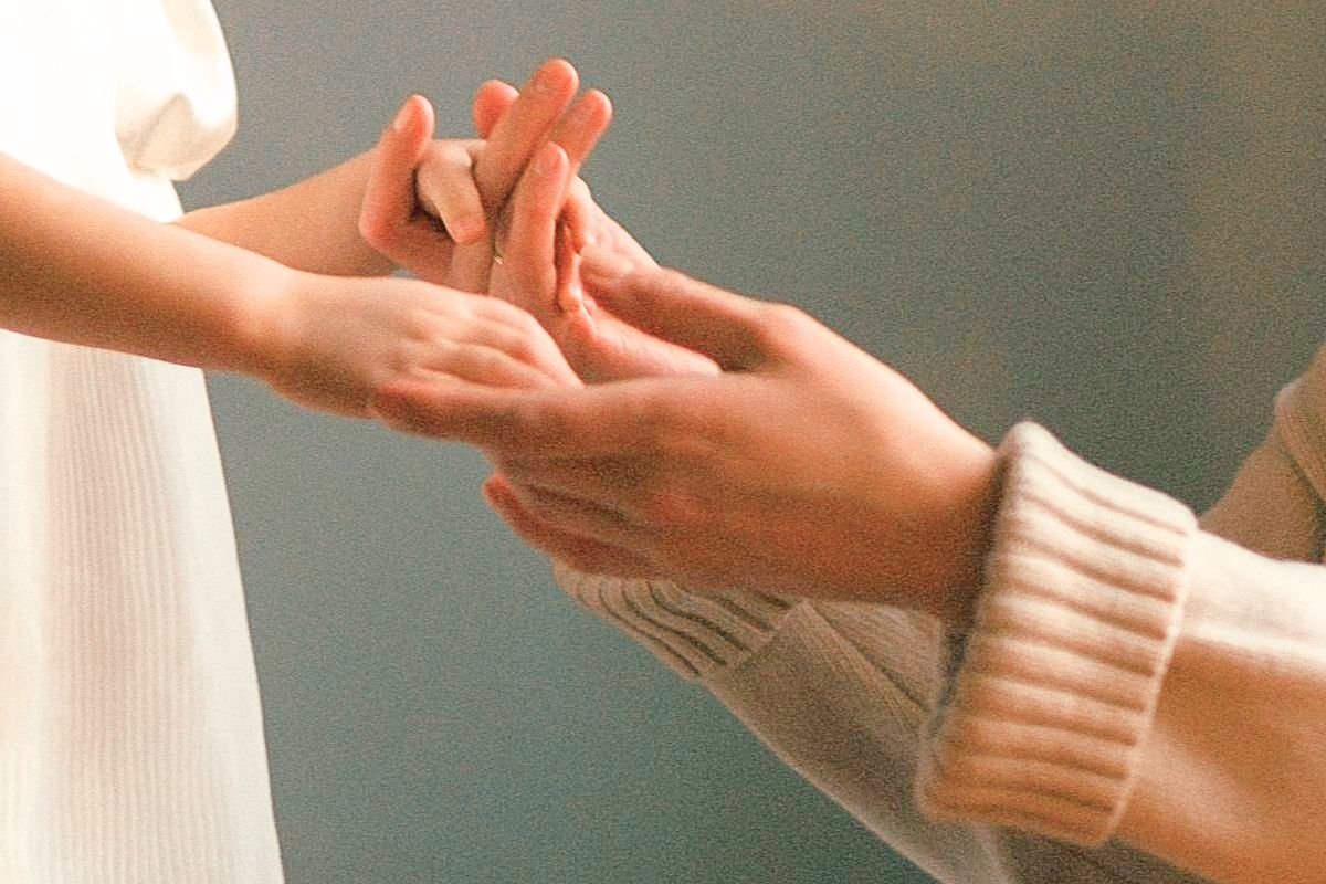 Adult holding hands with a young girl, representing healing the wounded inner child and overcoming childhood trauma.