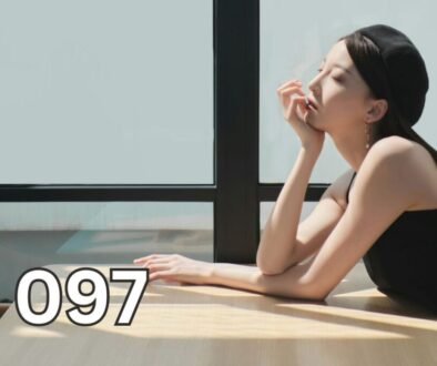 Woman sitting beside a window with her eyes closed, reflecting quietly as an illustration for an article explaining depression and major depressive disorder.