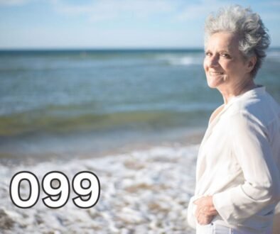 Smiling older woman standing on a beach, reflecting on life after losing a spouse and embracing hope for the future.