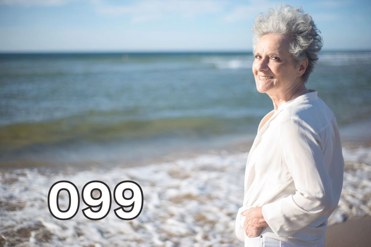 Smiling older woman standing on a beach, reflecting on life after losing a spouse and embracing hope for the future.