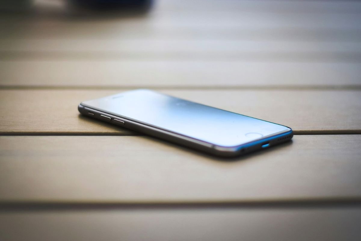 Smartphone resting on a wooden table, symbolising concerns about technology, excessive gaming, and modern child behaviour.