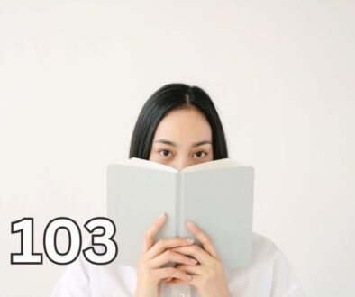 Woman covering her mouth with a book, representing the uncertainty and self-consciousness often associated with social anxiety vs introversion.