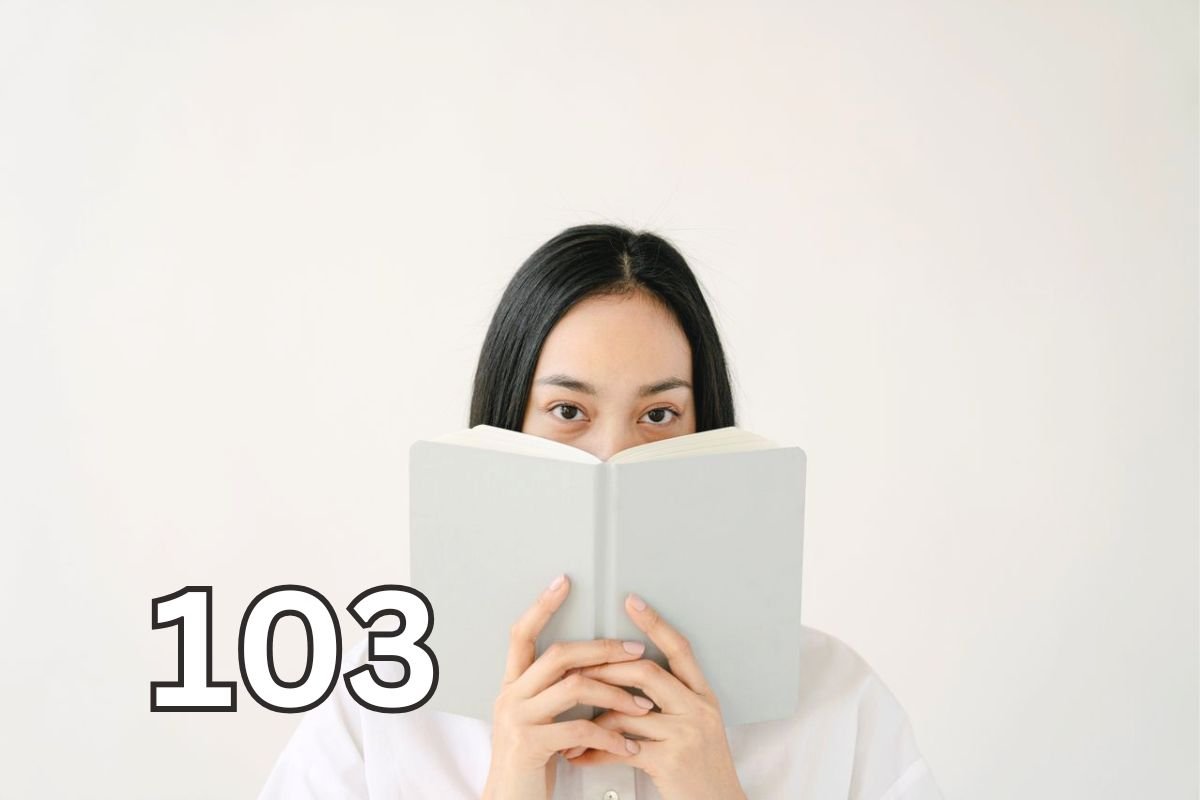 Woman covering her mouth with a book, representing the uncertainty and self-consciousness often associated with social anxiety vs introversion.