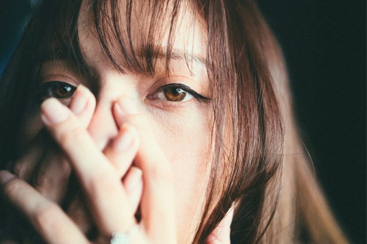 Woman covering her face with her hands, illustrating the emotional distress and self-consciousness often experienced with social anxiety disorder.