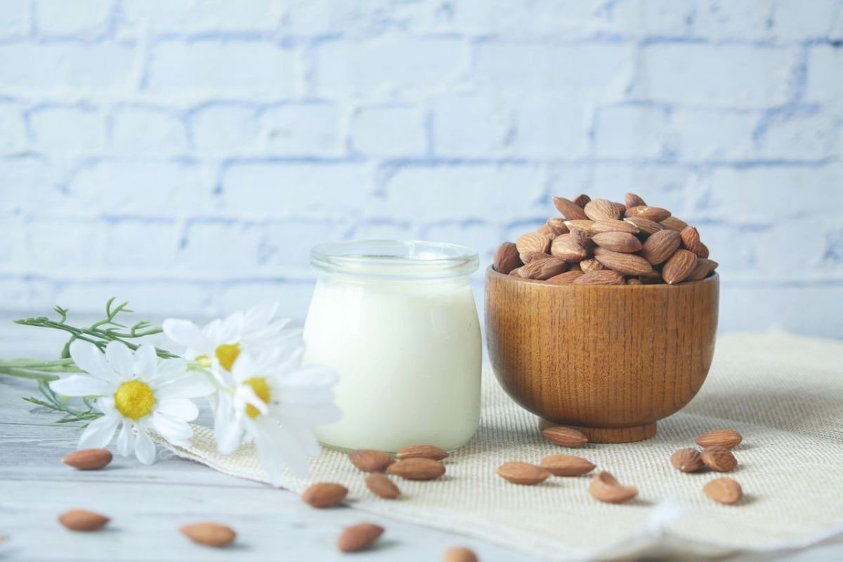 Glass of milk with almonds, two calcium-rich foods