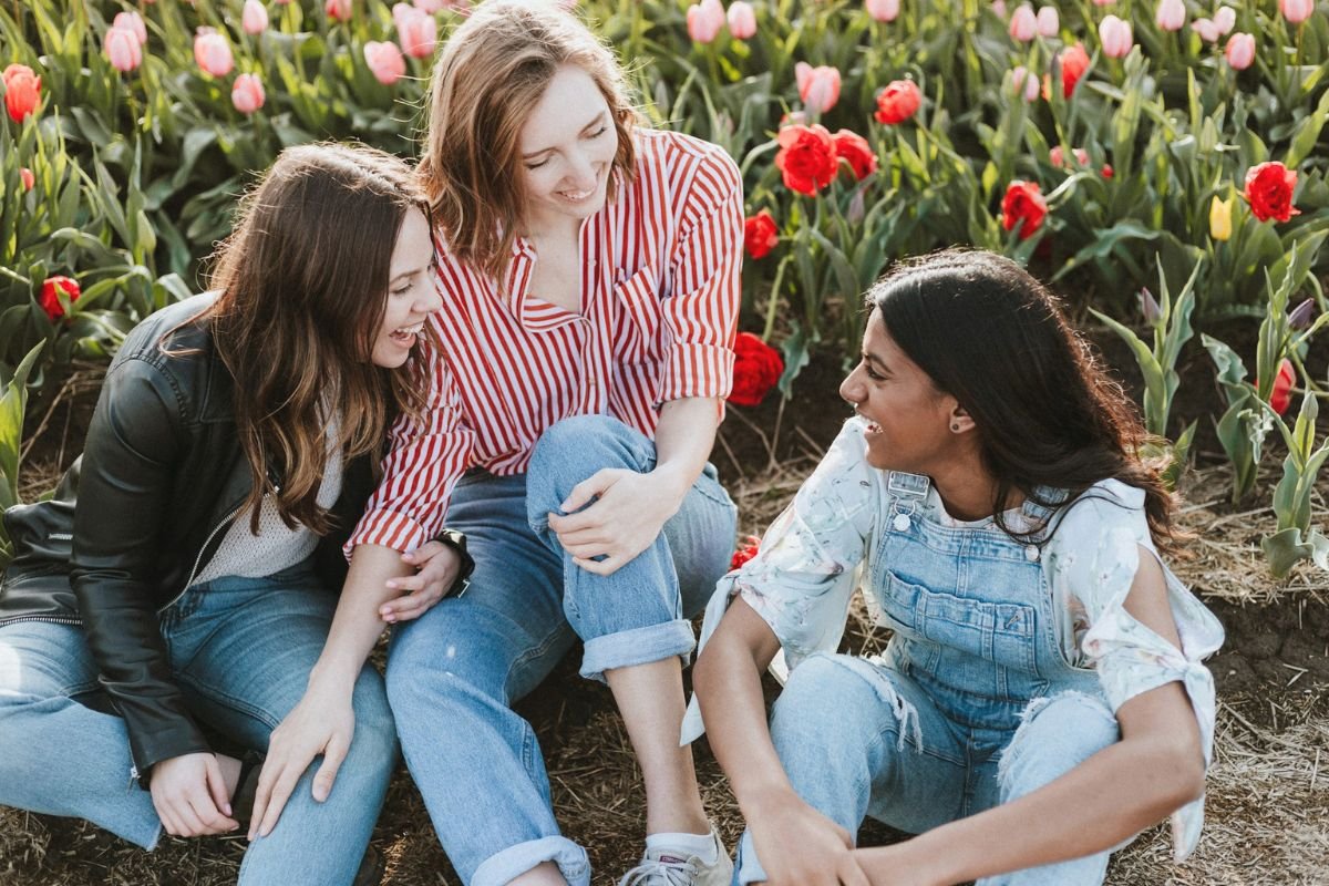Three friends sitting together and laughing