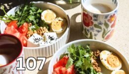 Healthy breakfast with eggs, fruit, coffee and flowers
