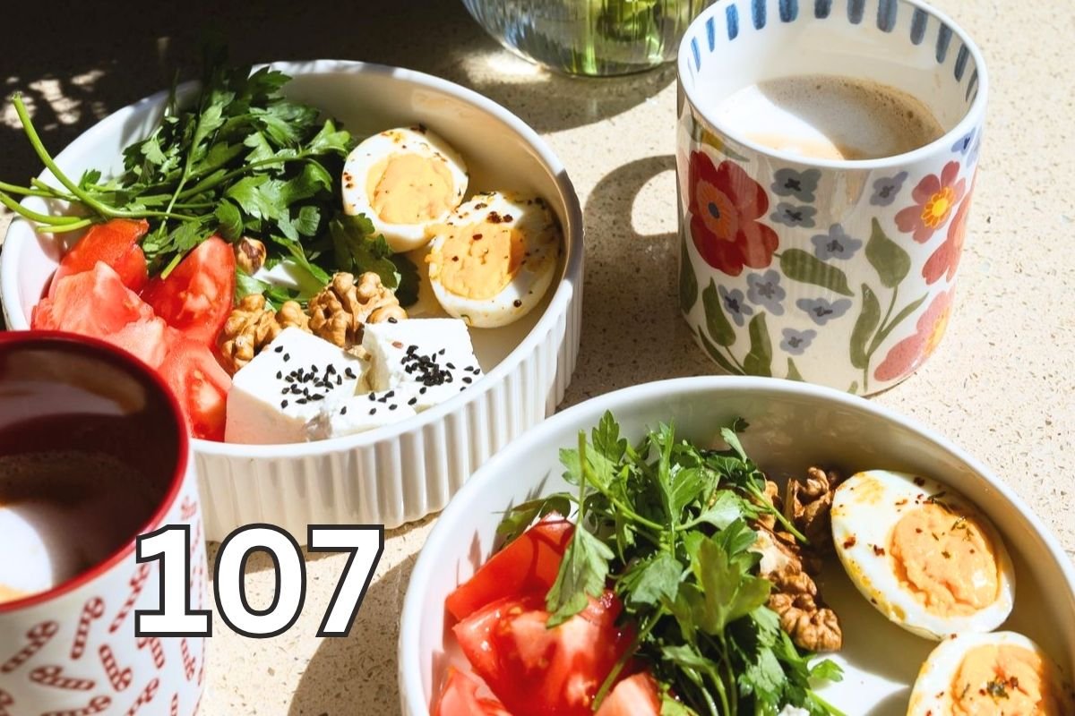 Healthy breakfast with eggs, fruit, coffee and flowers