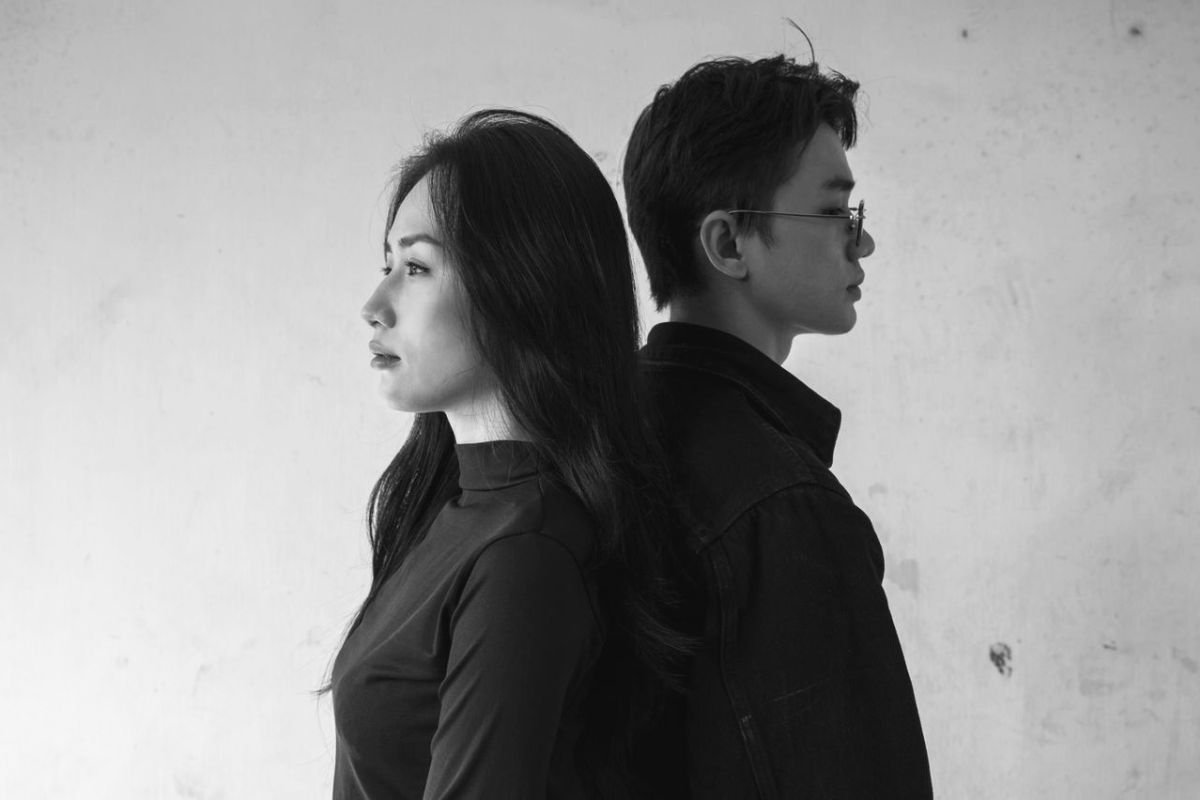 Couple standing back to back and looking away from each other