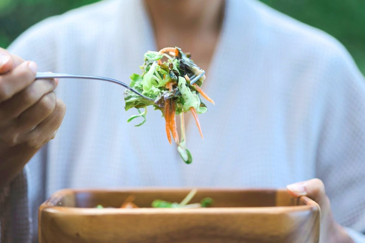 Person eating a healthy salad with a fork
