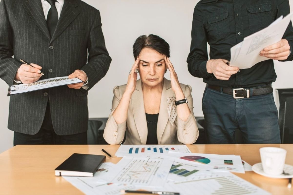 Mature woman overwhelmed by financial documents and investment advice