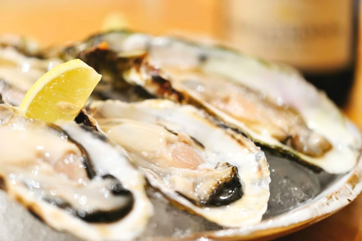 Plate of fresh oysters with lemon wedge